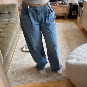 Pleated wide leg jeans with side buttons